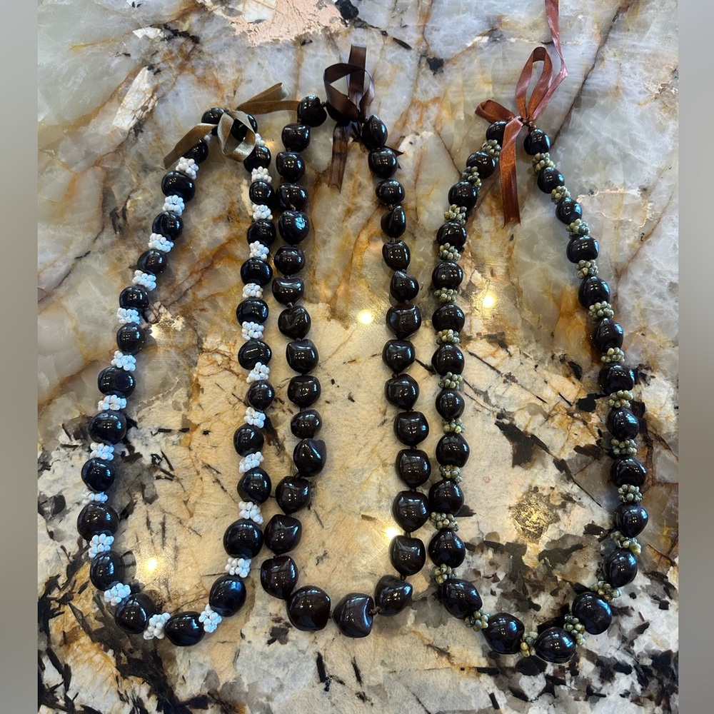 3 for $45. 2 Kukui Nut w/Mongo shells, 1 without. Each with Ribbon Tie 30”long